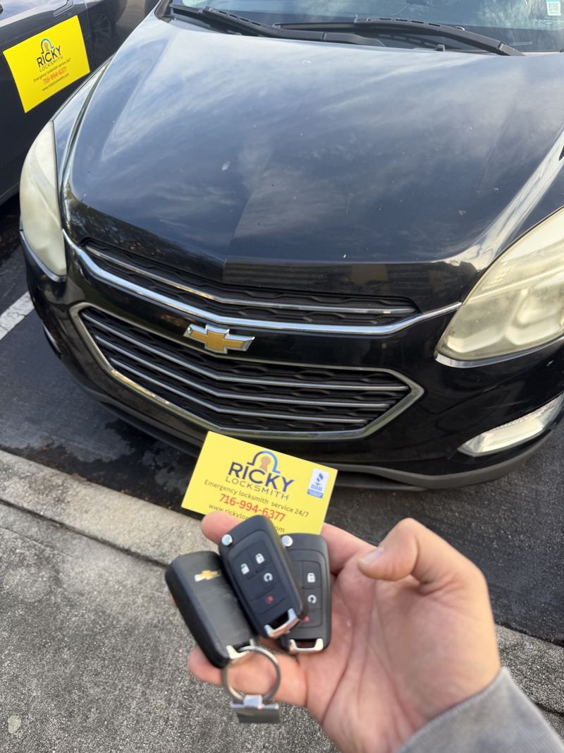 Three Chevrolet key fobs held in front of a Chevrolet