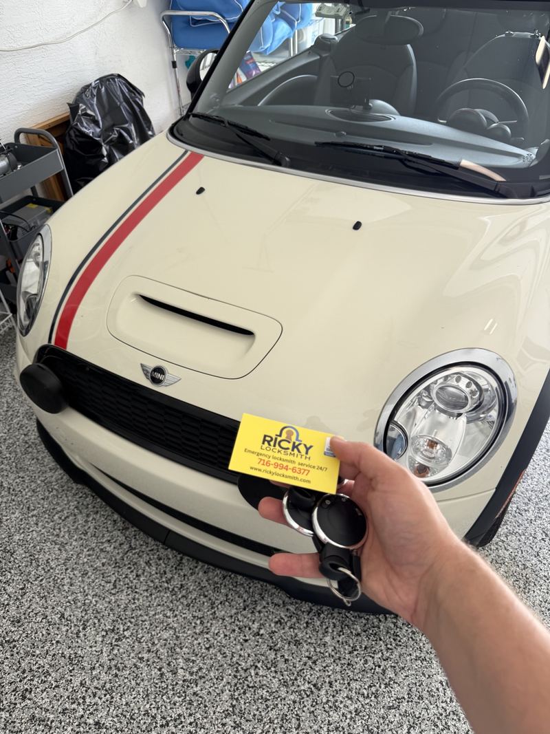 MINI Cooper key and Ricky Locksmith card in front of a MINI