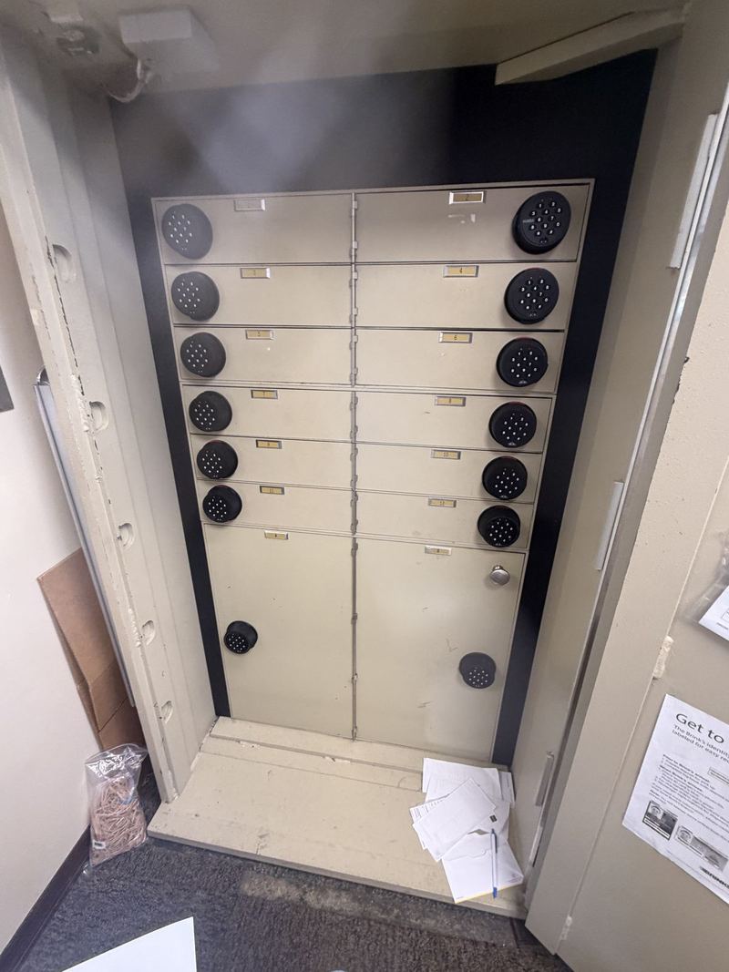 Open safe containing individually locked compartments