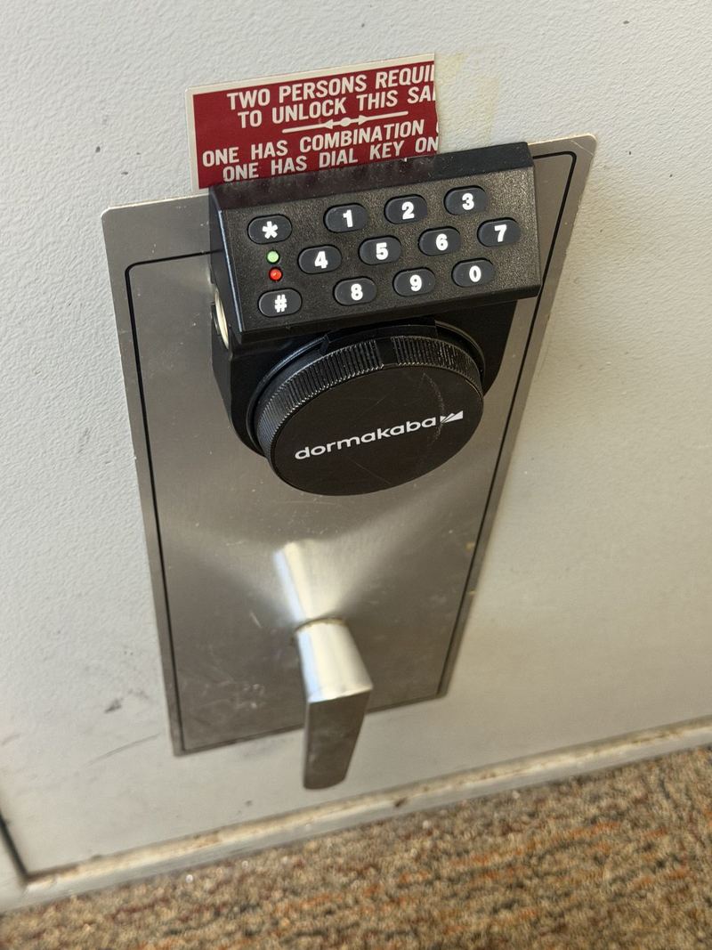 Close-up of an electronic safe keypad and handle