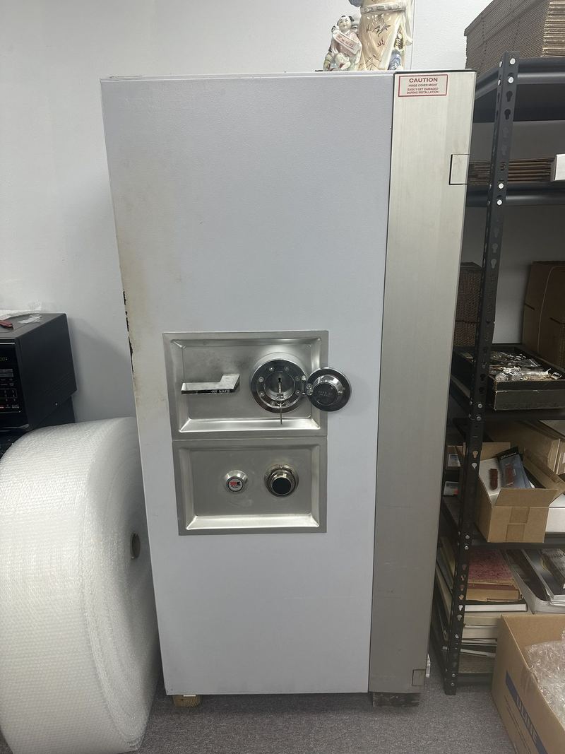 Tall gray safe with combination dial and handle
